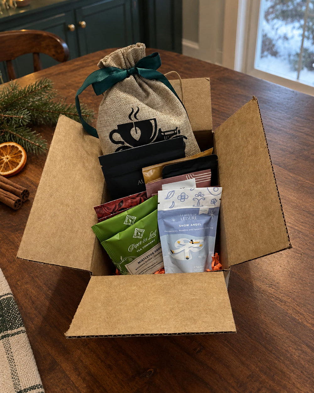 Winter craft tea collection in a Model Tea burlap gift bag on a walnut table